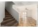 Living room with tile floors, access to patio, and carpeted stairs at 6705 W Orchid Ln, Peoria, AZ 85345