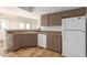 White appliances and brown cabinets in this kitchen at 6705 W Orchid Ln, Peoria, AZ 85345