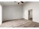 Spacious bedroom with carpeted floor, ceiling fan, and access to hallway at 6705 W Orchid Ln, Peoria, AZ 85345