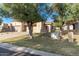 Tan two-car garage with arched entryway and landscaping at 10128 E Minnesota Ave, Sun Lakes, AZ 85248