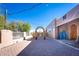 Inviting exterior with a paved courtyard, arched entryway, and charming landscaping at 15339 E Red Bird Rd, Scottsdale, AZ 85262