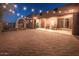 Inviting front porch with string lights, rocking chairs, and large planters at 15339 E Red Bird Rd, Scottsdale, AZ 85262