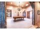 Game room with a pool table, chandelier, and rustic decor at 15339 E Red Bird Rd, Scottsdale, AZ 85262