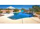 Relaxing pool area with patio umbrella and desert landscaping at 15339 E Red Bird Rd, Scottsdale, AZ 85262