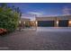 Landscaped side yard with mature plants, a zen garden, and a three-car garage at 15339 E Red Bird Rd, Scottsdale, AZ 85262