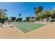 Community tennis court with tan colored court and green surface at 6138 N 28Th St, Phoenix, AZ 85016