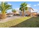 Landscaped backyard oasis with fire pit and palm trees at 11056 W Lane Ave, Glendale, AZ 85307