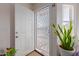 Front door entrance with security screen door and indoor plants at 6518 W Sonora St, Phoenix, AZ 85043