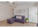 Living area with sectional sofa, decorative wall art, and large windows at 6518 W Sonora St, Phoenix, AZ 85043