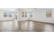 Bright and spacious living room with wood-look tile floors at 9911 S Caballo Dr, Apache Junction, AZ 85120