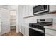 Stainless steel appliances and white cabinetry in a well-lit kitchen at 9911 S Caballo Dr, Apache Junction, AZ 85120