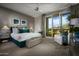 Bright bedroom with a comfortable bed and access to a balcony at 18720 N 101St St # 2017, Scottsdale, AZ 85255