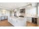 Modern kitchen with white cabinets, large island, and stainless steel appliances at 16580 N 92Nd St # 2001, Scottsdale, AZ 85260