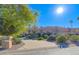 Tan house with tile roof, palm trees, and landscaped yard at 11165 E Gold Dust Ave, Scottsdale, AZ 85259