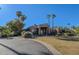 Tan house with tile roof, palm trees, and landscaped yard at 11165 E Gold Dust Ave, Scottsdale, AZ 85259