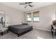 Bedroom with carpet, ceiling fan, and two large windows at 1406 W Main St # 137, Mesa, AZ 85201