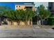 Front view of a two-story home with brick accents, lush landscaping, and gated entry at 1406 W Main St # 137, Mesa, AZ 85201