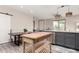 Kitchen and dining area with an island, gray cabinets, and wood floors at 1406 W Main St # 137, Mesa, AZ 85201