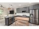 Modern kitchen featuring stainless steel appliances, a kitchen island, and updated grey cabinets at 1406 W Main St # 137, Mesa, AZ 85201