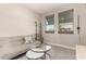 Living area with a gray couch, nesting coffee tables, and two large windows at 1406 W Main St # 137, Mesa, AZ 85201