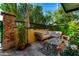 Private patio with seating area, surrounded by lush greenery and flowers at 1406 W Main St # 137, Mesa, AZ 85201