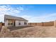 Spacious backyard with a covered patio and privacy wall at 23396 W Burton Ave, Buckeye, AZ 85326