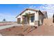 Exterior elevation of a single-story home with a two-car garage, landscaping, and a partially fenced yard at 23396 W Burton Ave, Buckeye, AZ 85326