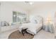 Spacious bedroom with a comfortable bed, window seat, and plantation shutters at 21844 N 79Th Pl, Scottsdale, AZ 85255