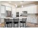 Modern kitchen with white cabinets and a large island at 16944 W Coronado Rd, Goodyear, AZ 85395