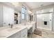 Double vanity bathroom with walk-in shower and natural light at 16944 W Coronado Rd, Goodyear, AZ 85395