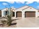 Two-car garage with Spanish style home at 16944 W Coronado Rd, Goodyear, AZ 85395
