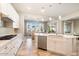 Open concept kitchen with island and view to living room at 16944 W Coronado Rd, Goodyear, AZ 85395