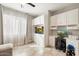 Home office boasts ample built-in cabinetry, desk, and window with natural light at 16944 W Coronado Rd, Goodyear, AZ 85395