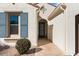 Inviting front entry with blue shutters and stone pathway at 16944 W Coronado Rd, Goodyear, AZ 85395