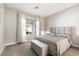 Spacious bedroom with plush bed and window overlooking patio at 16944 W Coronado Rd, Goodyear, AZ 85395