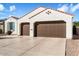 Two-car garage with Spanish style home at 16944 W Coronado Rd, Goodyear, AZ 85395
