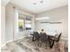 Bright dining room features a table with seating for six and large window overlooking backyard at 16944 W Coronado Rd, Goodyear, AZ 85395