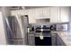 Modern kitchen with stainless steel appliances and white cabinets at 9618 N 66 Dr, Glendale, AZ 85302