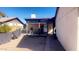 Backyard with covered patio, table and chairs, and a small walkway at 9618 N 66 Dr, Glendale, AZ 85302