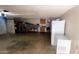 Spacious garage with extra storage, cabinets, and a refrigerator at 9618 N 66 Dr, Glendale, AZ 85302