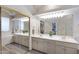 Double vanity bathroom with large mirror and a view into bedroom at 15203 N Castillo Dr, Fountain Hills, AZ 85268