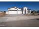 New construction home with three-car garage and arched entryway at 12308 W Parkway Ln, Avondale, AZ 85323