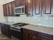 Stainless steel appliances and light beige backsplash in this modern kitchen at 12308 W Parkway Ln, Avondale, AZ 85323