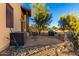 Landscaped backyard with a partially visible home and rock features at 14129 E Barbie Ln, Scottsdale, AZ 85262