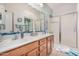 Clean bathroom with double vanity, tiled shower, and large mirror at 18478 N Canal Dr, Surprise, AZ 85374