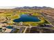 Aerial view of community lake, walking paths, and green spaces at 12311 W Parkway Ln, Avondale, AZ 85323