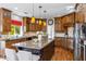 Large kitchen with granite island and dark wood cabinets at 10647 N 82Nd Pl, Scottsdale, AZ 85260