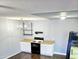 White kitchen cabinets, black appliances, and wood-look floors at 1440 N Idaho Rd # 2041, Apache Junction, AZ 85119