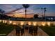 Relaxing backyard patio with fire pit and seating, overlooking golf course at 5525 E Lincoln Dr # 124, Paradise Valley, AZ 85253