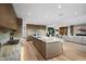 Open concept kitchen with island, hardwood floors, and living room view at 5525 E Lincoln Dr # 124, Paradise Valley, AZ 85253